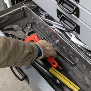 Person reaching for tools into Stellar's work truck drawer with egg crate dividers.