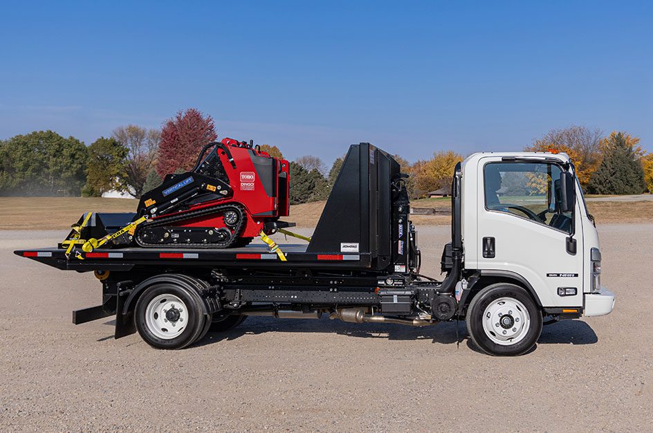 Small truck with bulldozer on truckbed