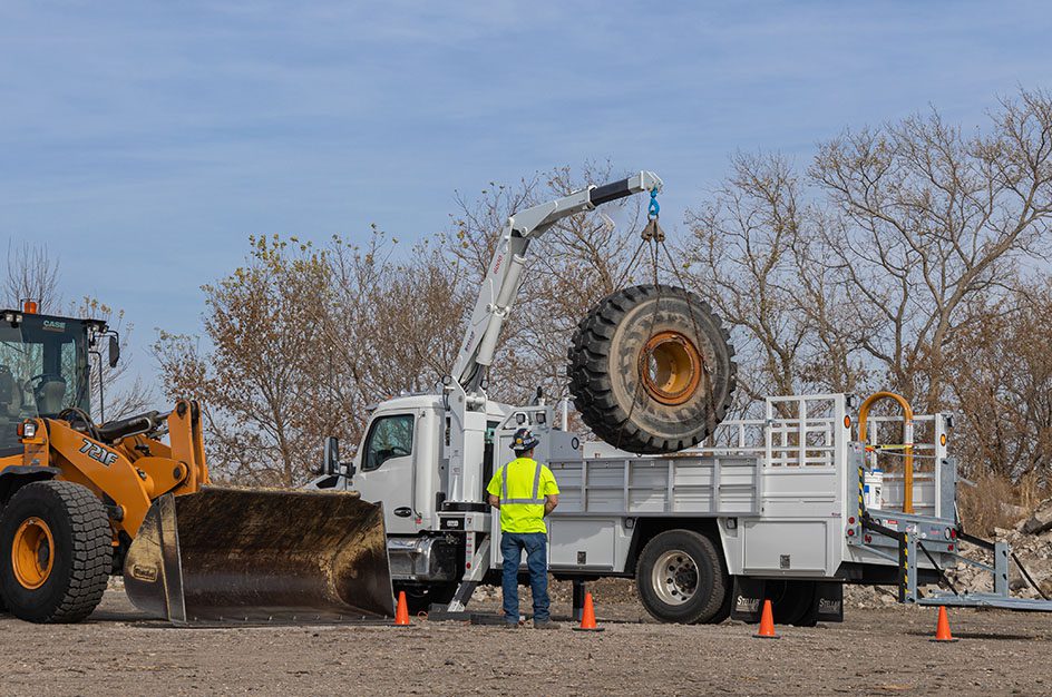 Stellar crane holding large construction tire