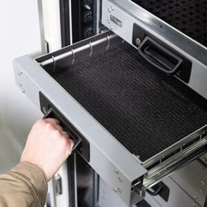 Person opening Stellar's work truck drawers with bale-style pull handles and non-slip drawer liners.
