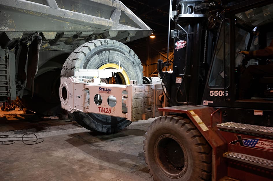 TM28 Tire Manipulator changing a tire on dump truck close-up